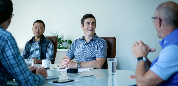 New Harbor Capital investment team working together in our Chicago private equity firm office.