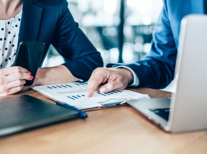 High-tech private equity professionals collaborating on business intelligence and data analytics graphs