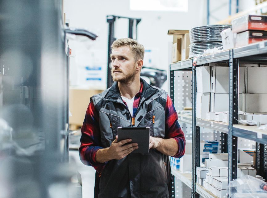 Supply chain and logistics professional taking inventory in warehouse