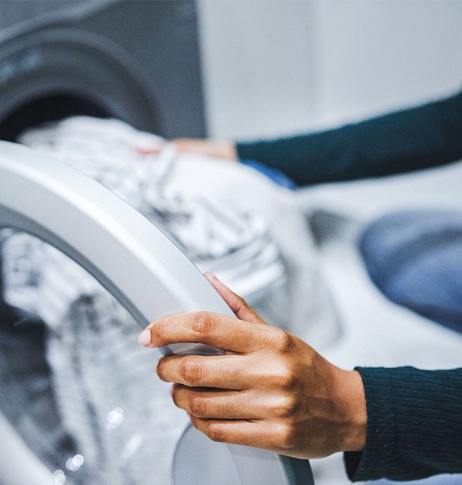 Employee installing WASH Multifamily Laundry Systems