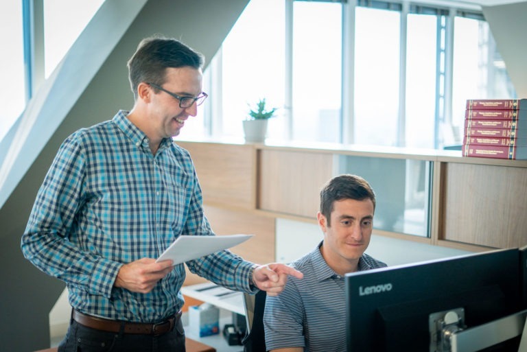 New Harbor Capital investment team members collaborate on a private equity deal.