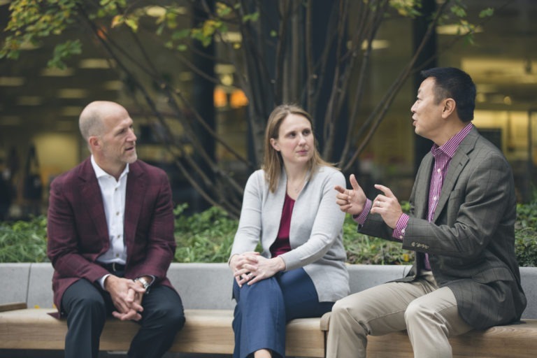 New Harbor Capital private equity investment team members collaborate on a deal