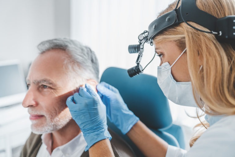 Ear, nose, and throat ENT doctor from ENTPSA examines a healthcare patient